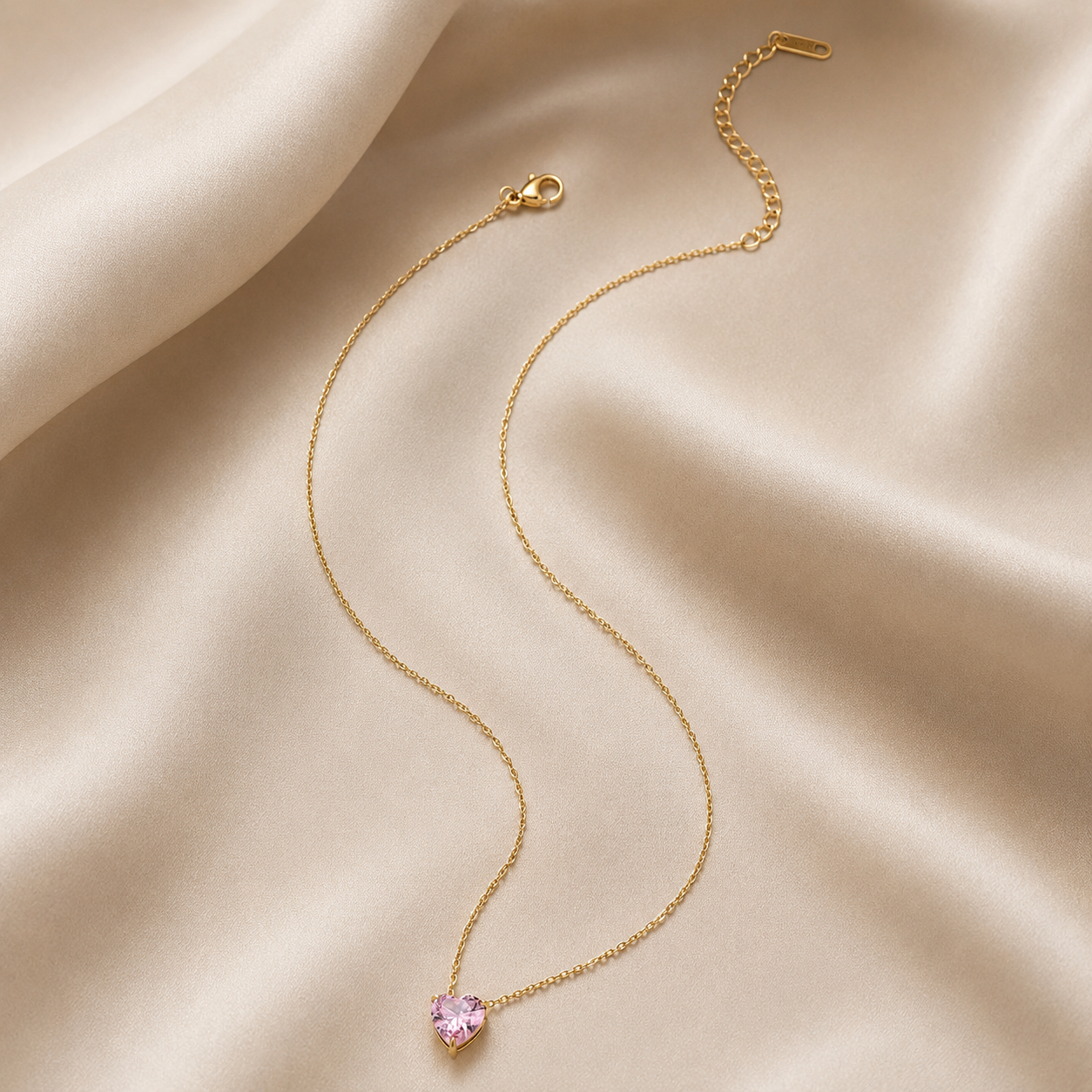 Elegant pink heart zircon necklace displayed on soft fabric background