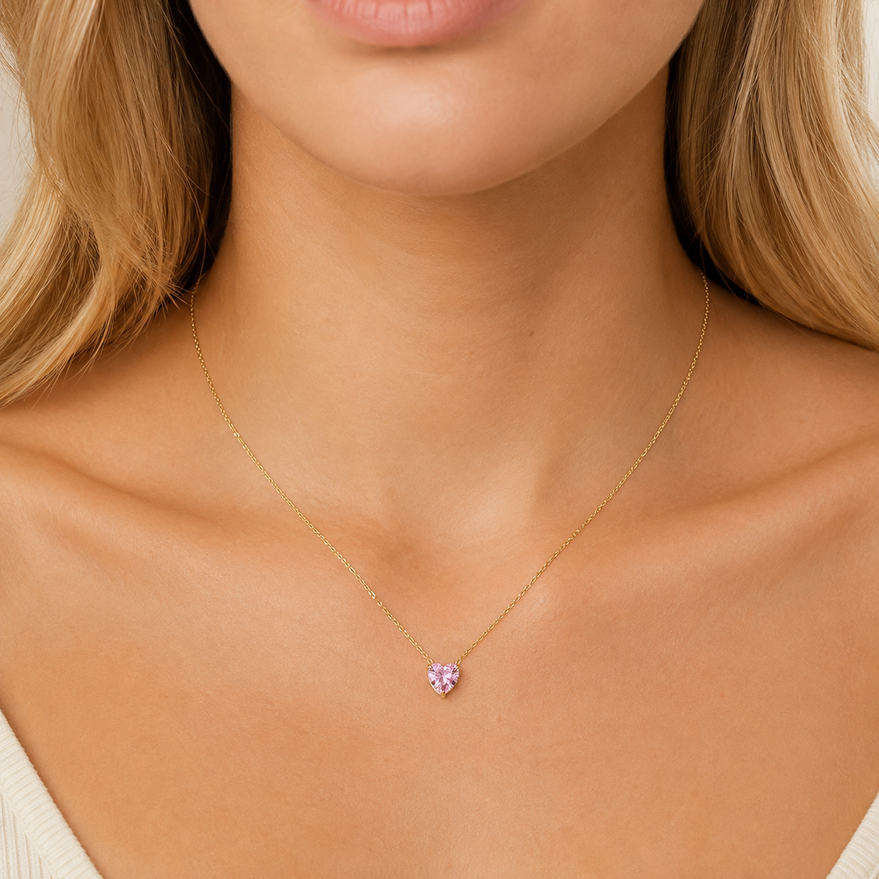 Woman wearing delicate pink heart zircon pendant necklace