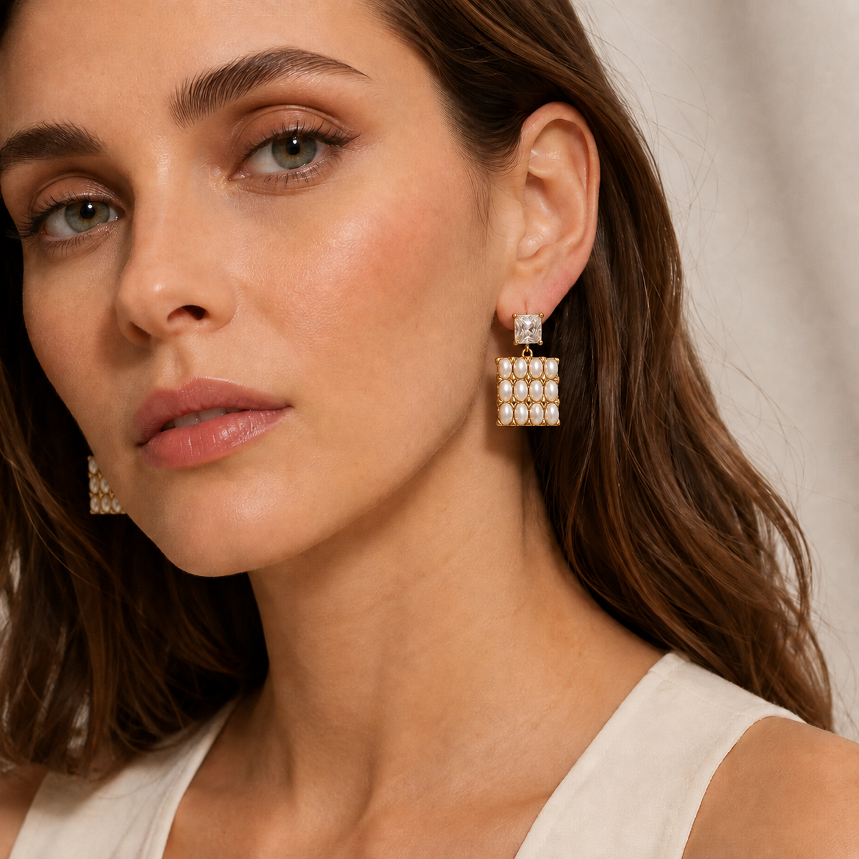Woman Wearing Pearl Geometric Earrings with Zircon Stones and Modern Jewelry Style